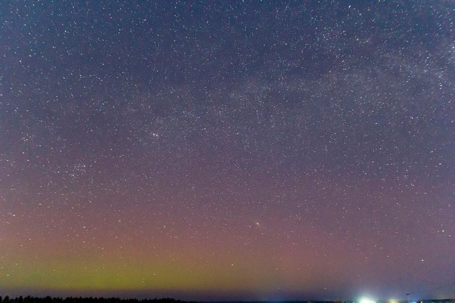 Северное сияние (aurora borealis) и Млечный путь на звёздном небе ночью в конце марта в Кировской области